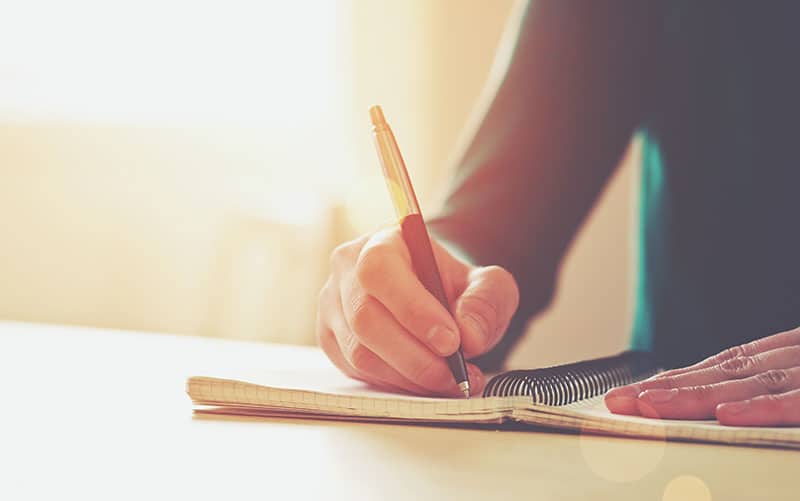 a person writing an obituary