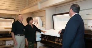 Funeral Director Garrett Jacobs shows some clients the different caskets available