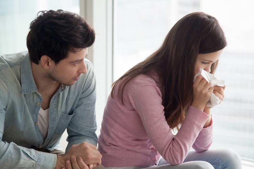 man consoling a woman