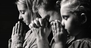 people praying at a funeral