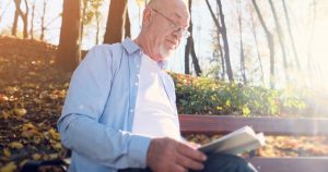 man reading book on grief