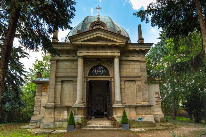 A stone mausoleum in a clearing.